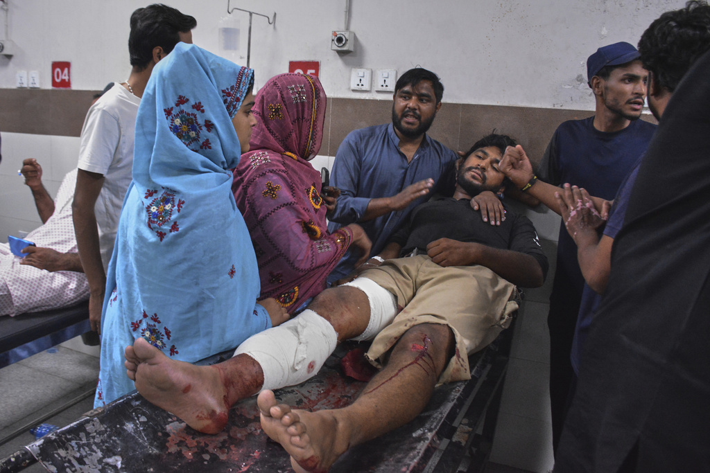 Family members comfort an injured victim of suicide bombing who is receiving treatment at a hospital in Quetta, Pakistan, Tuesday, Sept. 2, 2025. (AP Photo/Arshad Butt)