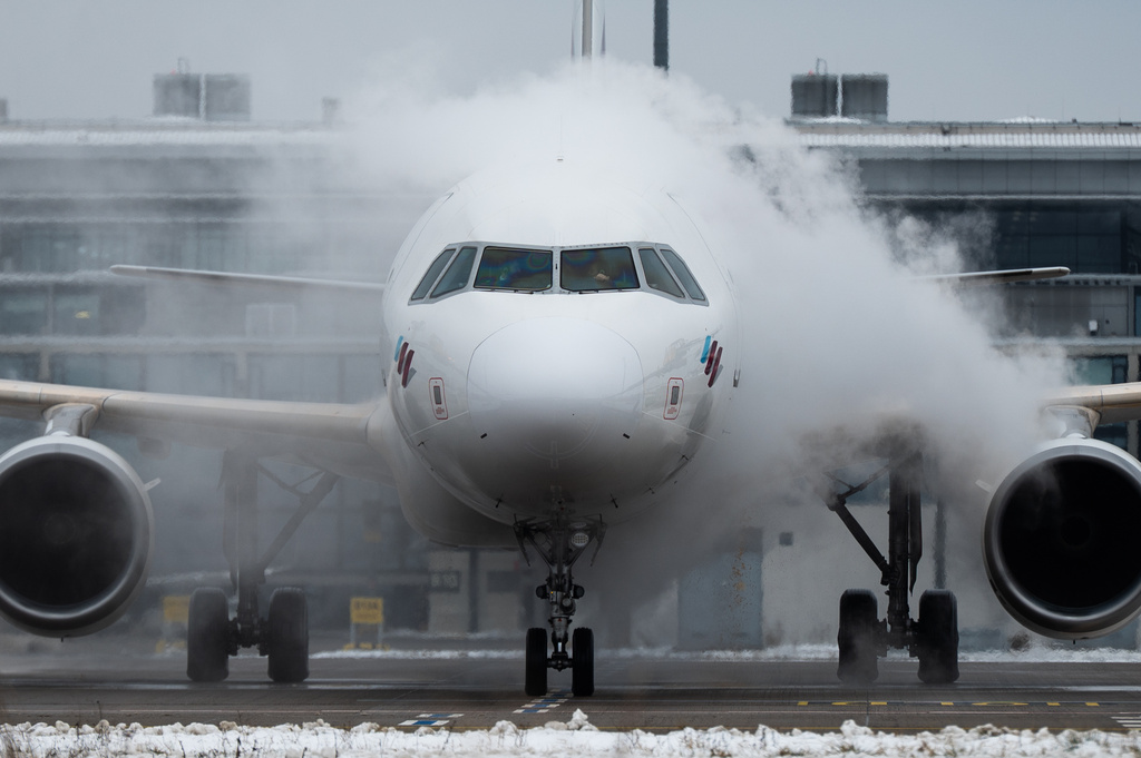 A Eurowings aircraft is de-iced at Berlin-Brandenburg Airport, Germany, Friday Jan. 9, 2026. (Christophe Gateau/dpa via AP)