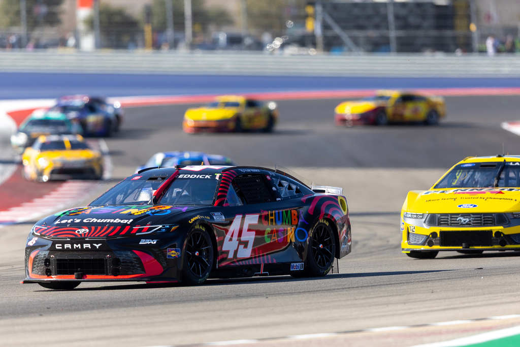 23XI Racing's Tyler Reddick (45) and Team Penske's Ryan Blaney drive through Turn 13 during a NASCAR Cup Series auto race in Austin, Texas, Sunday, March 1, 2026. (AP Photo/Stephen Spillman)