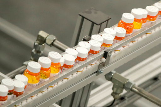 FILE - Bottles of medicine ride on a conveyor belt at a mail-in pharmacy warehouse in Florence, N.J., on July 10, 2018. (AP Photo/Julio Cortez, File) FILE - Bottles of medicine ride on a conveyor belt at a mail-in pharmacy warehouse in Florence, N.J., on July 10, 2018. (AP Photo/Julio Cortez, File)