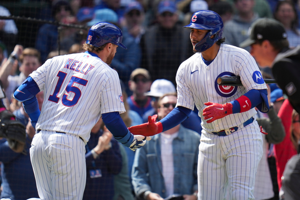 Chicago Cubs' Carson Kelly (15), left, celebrates with Miguel Amaya (9) after hitting a three-run home run during the sixth inning of a baseball game against the New York Mets, Saturday, April 18, 2026, in Chicago. (AP Photo/Erin Hooley)
