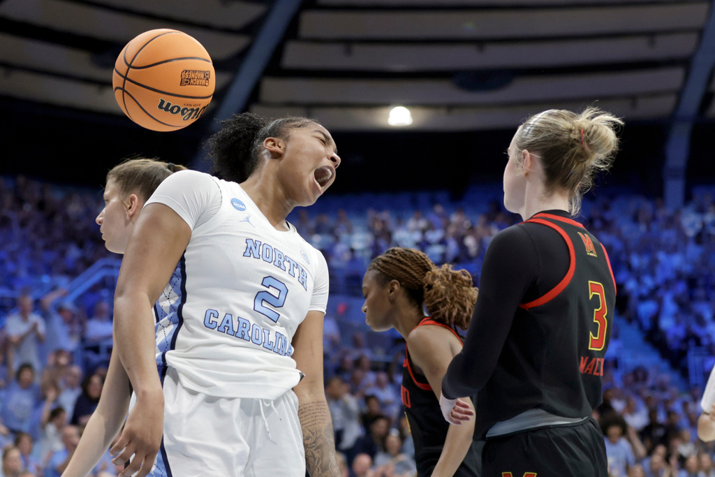 North Carolina forward Nyla Harris (2) celebrates after she scored with Maryland guard Addi Mack (3) nearby during the first half in the second round of the NCAA college basketball tournament, Sunday, March 22, 2026, in Chapel Hill, N.C. (AP Photo/Chris Seward)