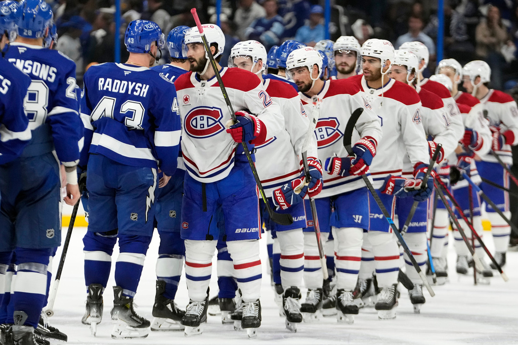 Montréal Canadiens center Phillip Danault (24) leads the team through the handshake line after the Canadiens defeated the Lightning in Game 7 of an NHL hockey Stanley Cup first-round playoff series, Sunday, May 3, 2026, in Tampa, Fla. (AP Photo/Chris O'Meara)