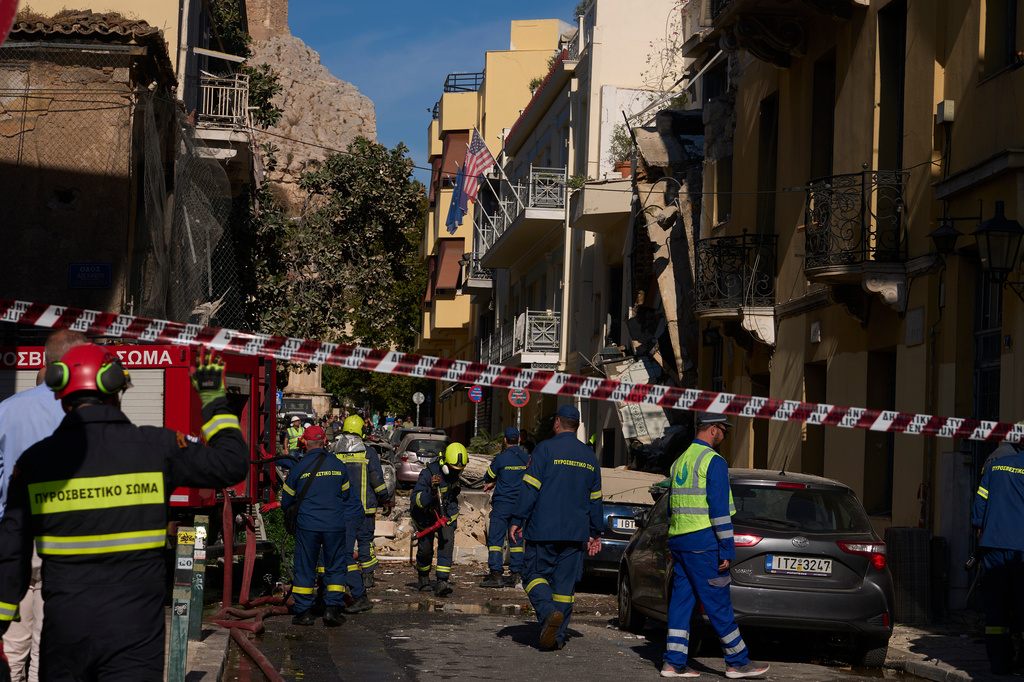 Firefighters work at the scene following a powerful blast that caused a building to collapse and injured at least two people in Athens' Plaka district, Friday, Sept. 25, 2026. (AP Photo/Petros Giannakouris)