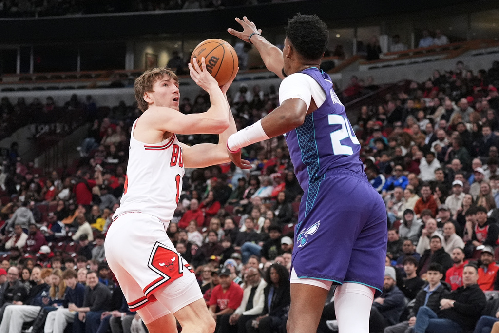 Chicago Bulls forward Matas Buzelis, left, shoots against Charlotte Hornets forward Brandon Miller during the first half of an NBA basketball game in Chicago, Tuesday, Feb. 24, 2026. (AP Photo/Nam Y. Huh)