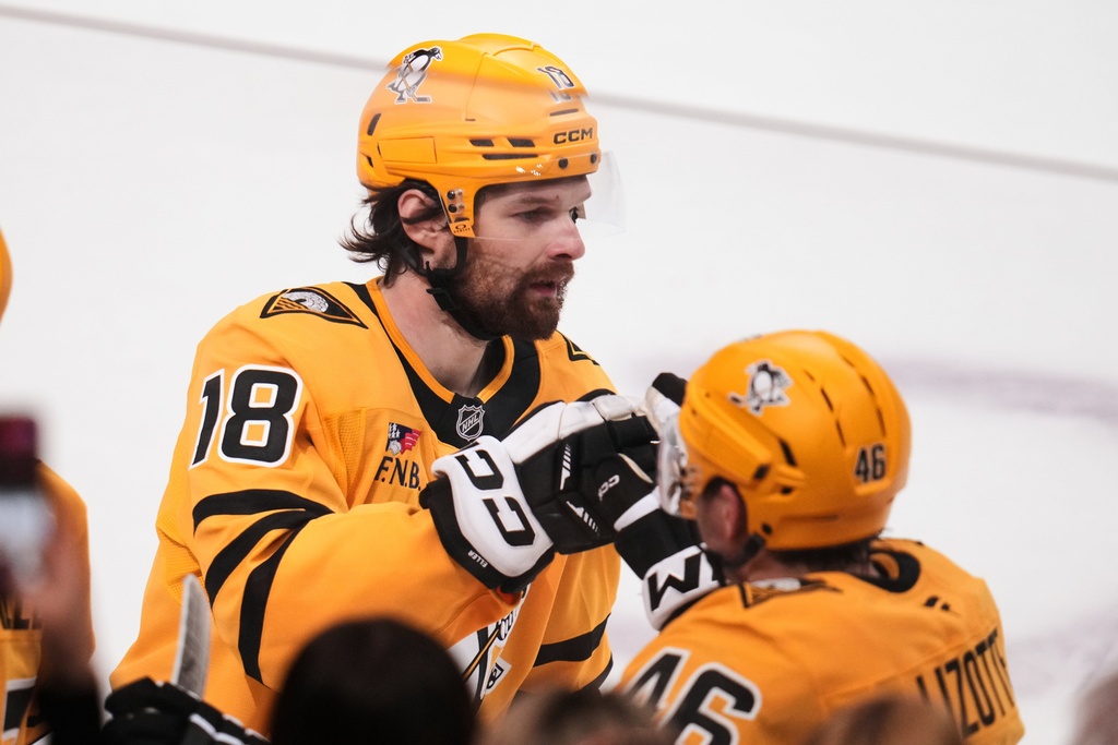 Pittsburgh Penguins' Tommy Novak (18) returns to the bench after scoring during the first period of an NHL hockey game against the New Jersey Devils in Pittsburgh, Thursday, Feb. 26, 2026. (AP Photo/Gene J. Puskar)