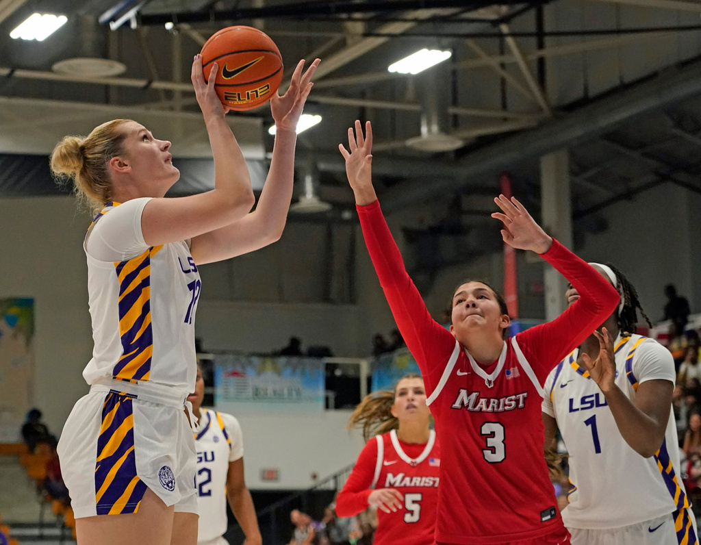 LSU forward Kate Koval, left, looks to shoot a jump shot over Marist guard Justine Henry (3) during the second quarter of an NCAA college basketball game at the Paradise Jam tournament Friday, Nov. 28, 2025, in St. Thomas, U.S. Virgin Islands. (Bill Kiser/The Virgin Islands Daily News via AP)