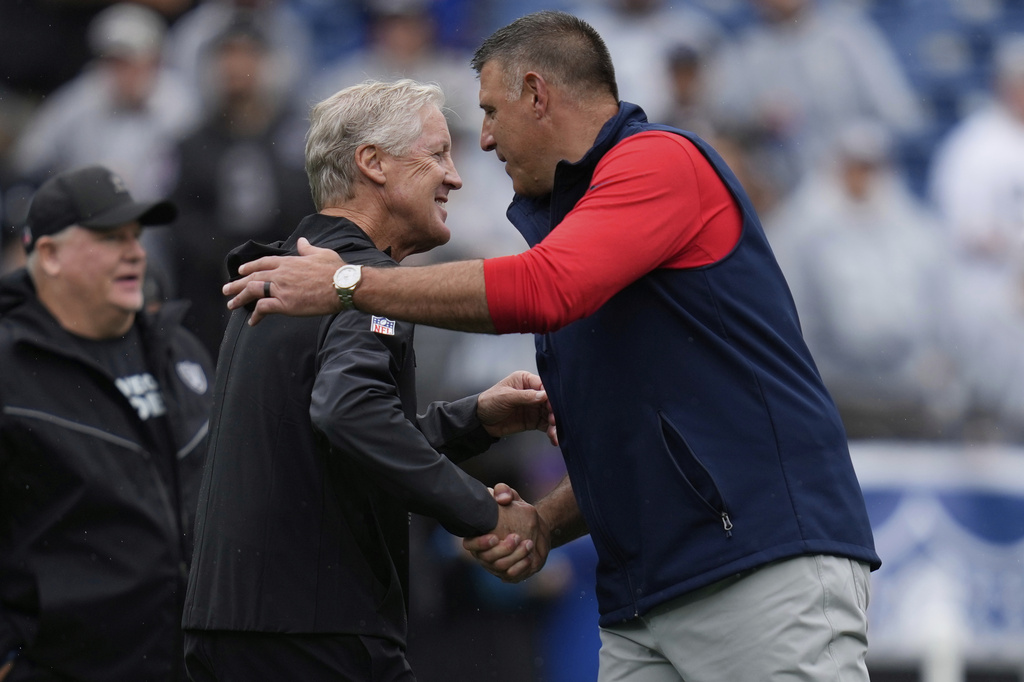 Las Vegas Raiders head coach Pete Carroll, left, and New England Patriots head coach Mike Vrabel greet each other before an NFL football game, Sunday, Sept. 7, 2025, in Foxborough, Mass. (AP Photo/Charles Krupa)