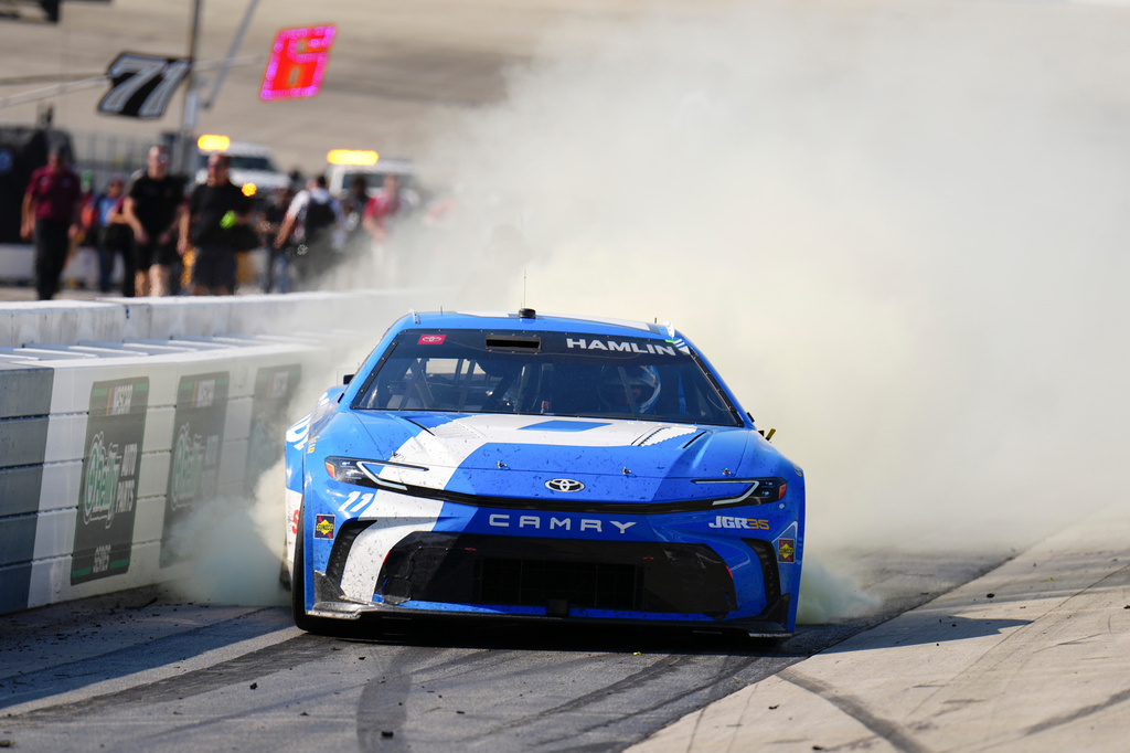 Denny Hamlin celebrates with a burnout after winning the NASCAR All-Star auto race at Dover Motor Speedway, Sunday, May 17, 2026, in Dover, Del. (AP Photo/Derik Hamilton)