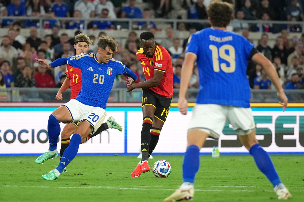 Belgium's Dodi Lukebakio, center, avoids Italy's Daniel Maldini to shoot and score his side's second goal during the Nations League soccer match between Italy and Belgium in Rome, Friday, Sept. 25, 2026. (AP Photo/Andrew Medichini)