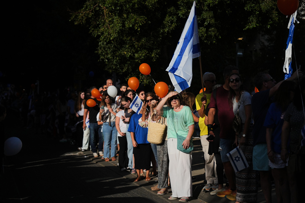 People gather to welcome freed Israeli hostage Evyatar David, recently released from Hamas captivity in Gaza, as he returns home from the hospital to Kfar Saba, Israel, Sunday, Oct. 26, 2025. (AP Photo/Ariel Schalit)