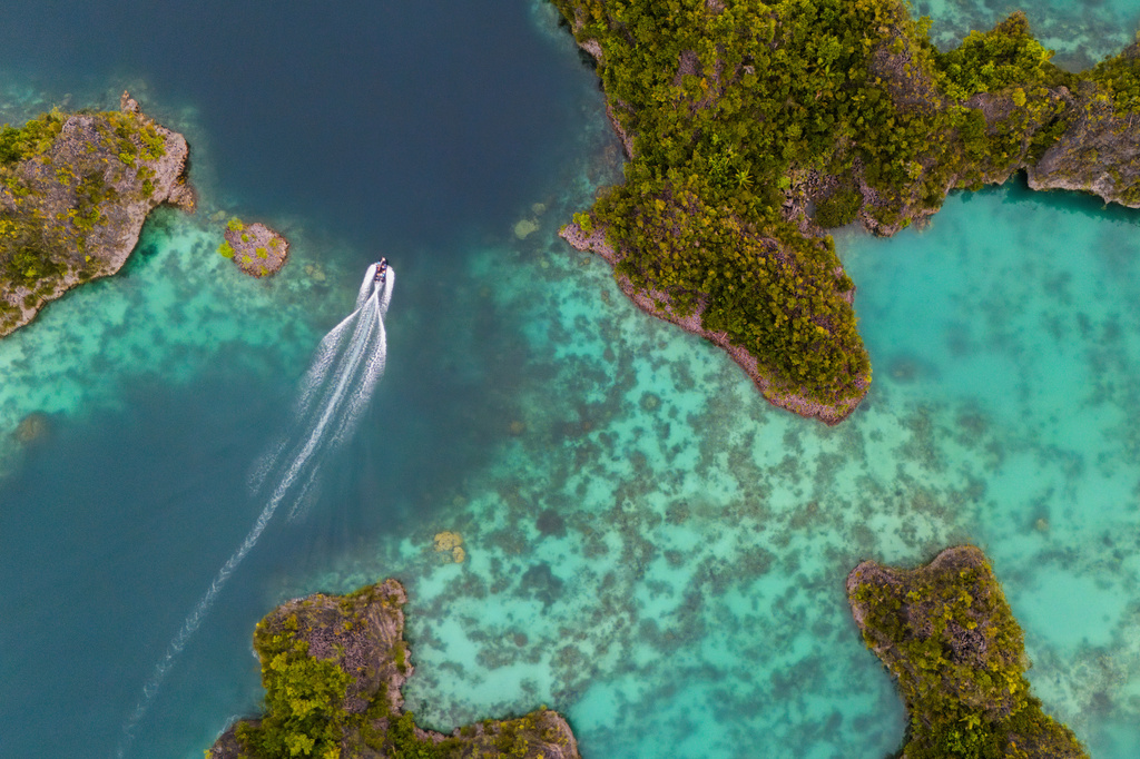 A speedboat crosses the Waigeo Barat islands, Raja Ampat, Indonesia, Thursday, March 5, 2026. (AP Photo/Claudia Rosel)