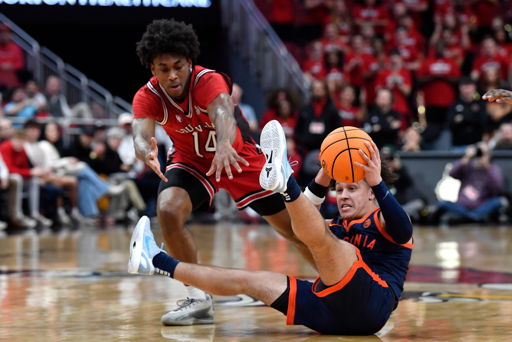 Virginia guard Chance Mallory (2) looks to pass the ball away from Louisville guard Adrian Wooley (14) during the first half of an NCAA college basketball game in Louisville, Ky., Tuesday, Jan. 13, 2026. (AP Photo/Timothy D. Easley)