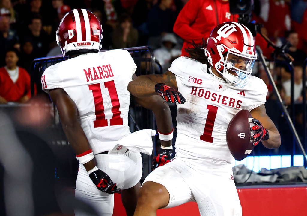 Indiana running back Turbo Richard (1) celebrates with Nick Marsh (11) after scoring a touchdown against Rutgers during the first half of an NCAA college football game, Saturday, Oct. 3, 2026, in Piscataway, N.J. (AP Photo/Noah K. Murray)