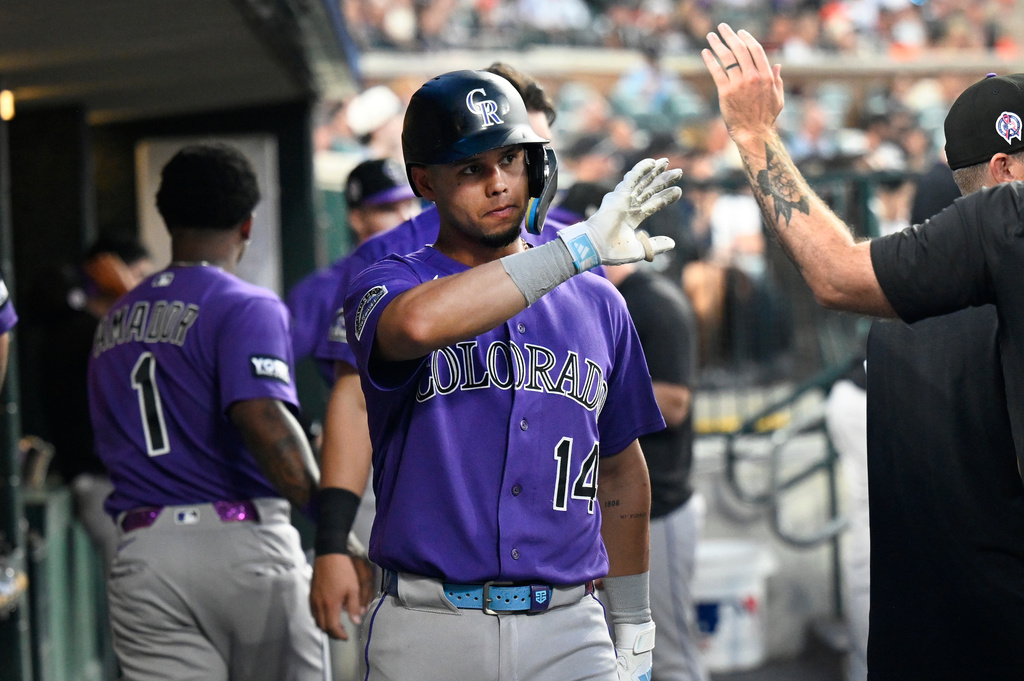 Colorado Rockies' Ezequiel Tovar (14) is congratulated by teammates after scoring a run during the fifth inning of a baseball game against the Detroit Tigers, Friday, Sept. 11, 2026, in Detroit. (AP Photo/Jose Juarez)
