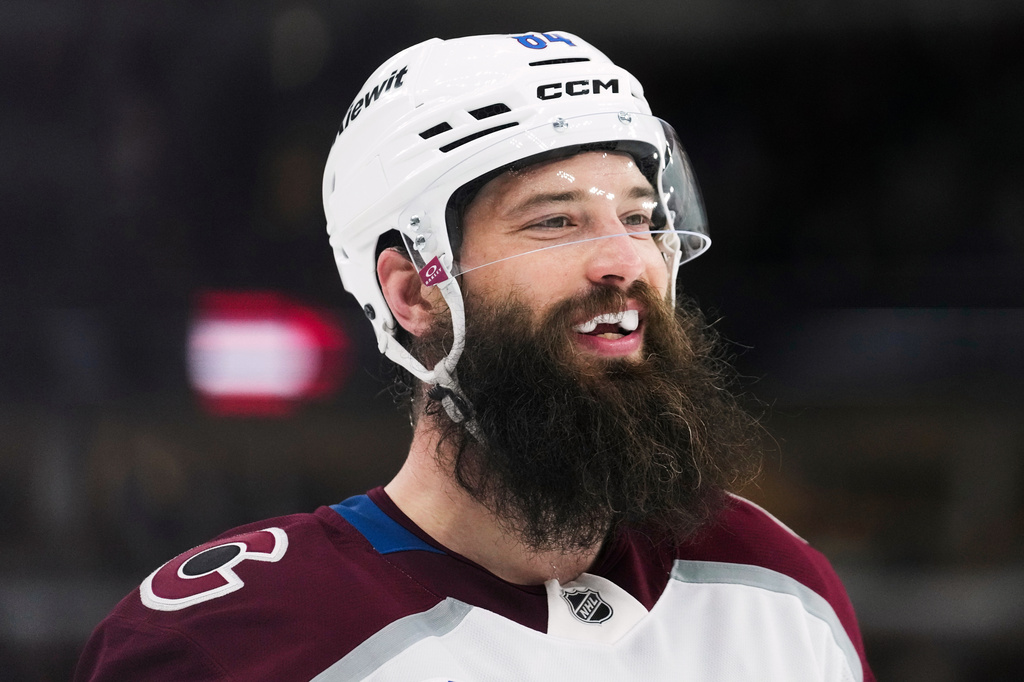 FILE - Colorado Avalanche defenseman Brent Burns smiles at his teammates at the end of the first period of an NHL hockey game against the Chicago Blackhawks, March 20, 2026, in Chicago. (AP Photo/Erin Hooley, File)