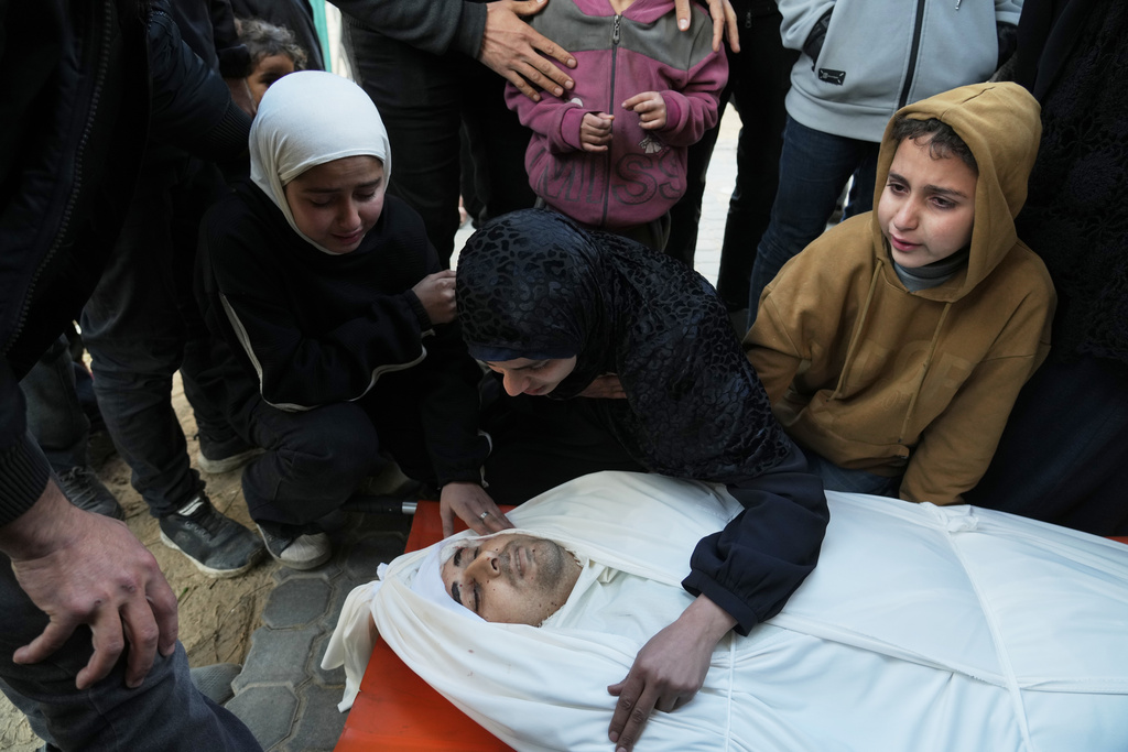 Palestinian wife and children bid farewell to their father, Youssef Haboush, who was killed in an Israeli military strike, at Shifa Hospital in Gaza City, Wednesday, Feb. 4, 2026. (AP Photo/Jehad Alshrafi)