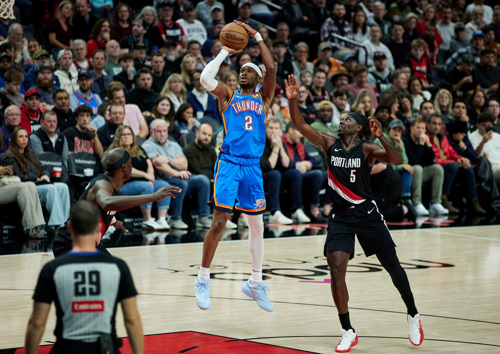 Oklahoma City Thunder guard Shai Gilgeous-Alexander (2) shoots over Portland Trail Blazers guard Jrue Holiday during the second half of an NBA basketball game in Portland, Ore., Wednesday, Nov. 5, 2025. (AP Photo/Craig Mitchelldyer)