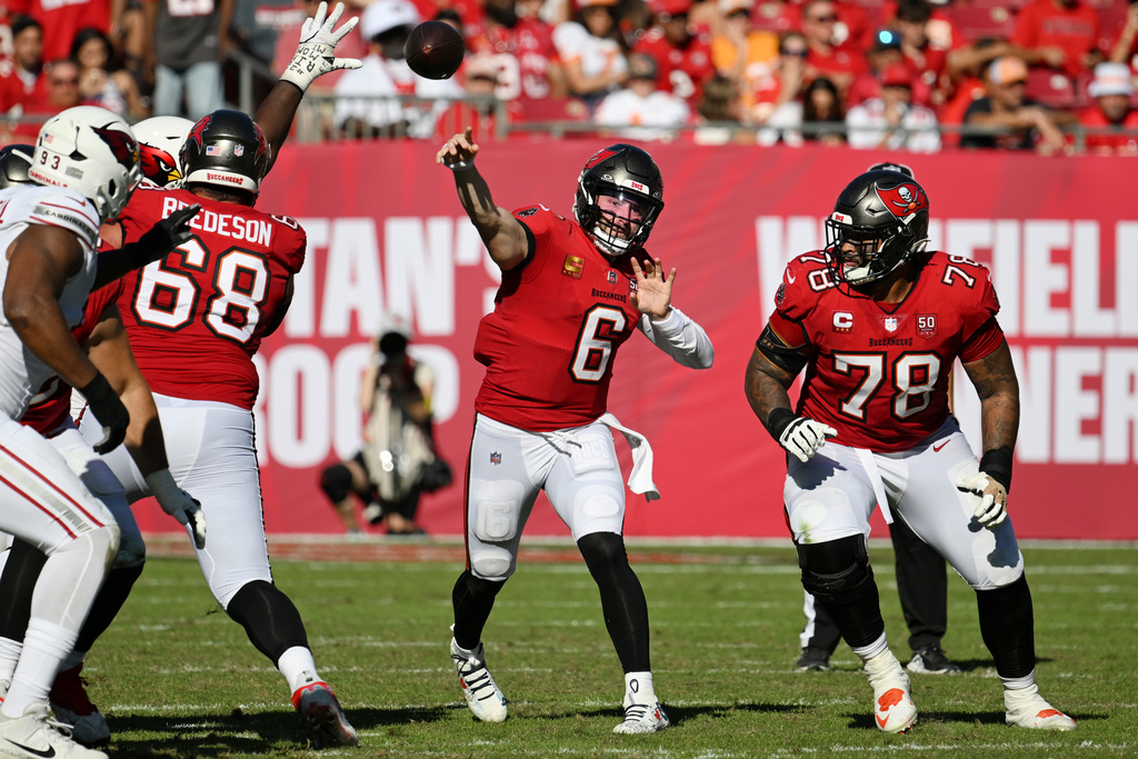 Tampa Bay Buccaneers quarterback Baker Mayfield (6) throws between Buccaneers guard Ben Bredeson (68) and Buccaneers offensive tackle Tristan Wirfs (78) during the second half of an NFL football game Sunday, Nov. 30, 2025, in Tampa, Fla. (AP Photo/Jason Behnken)