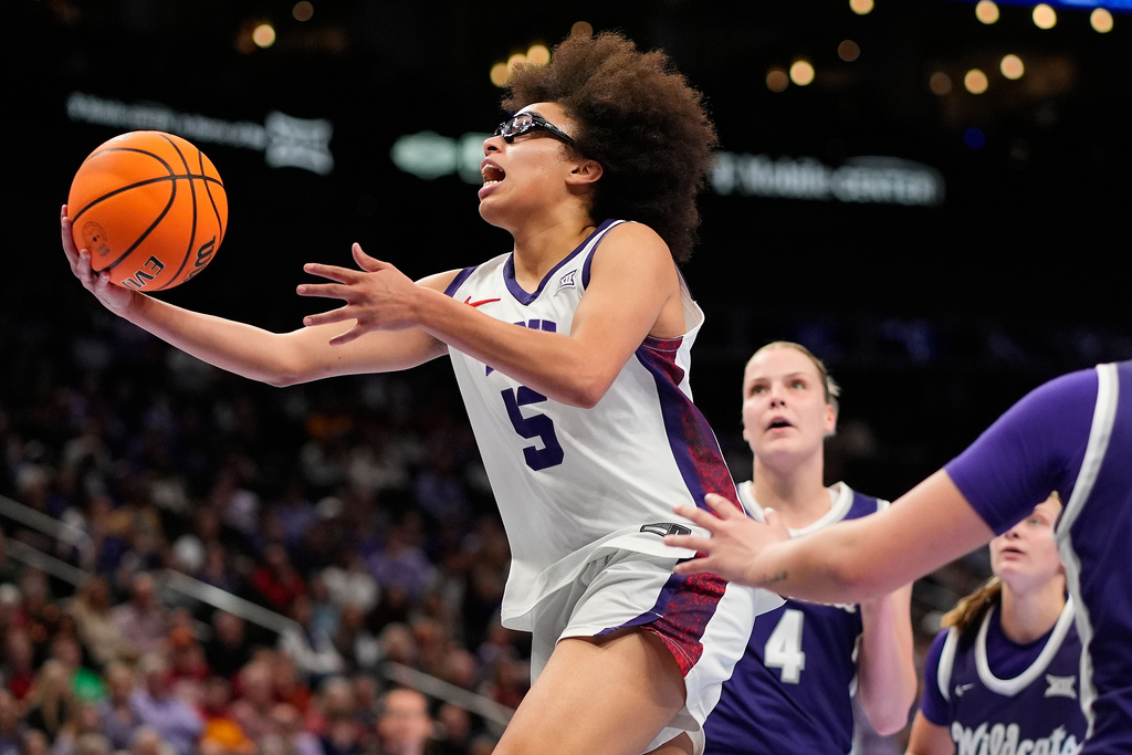 TCU's Olivia Miles (5) puts up a shot during second half of an NCAA college basketball game against Kansas State, in the semifinals of the Big 12 Conference tournament Saturday, March 7, 2026, in Kansas City, Mo. (AP Photo/Charlie Riedel)