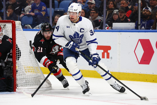 Toronto Maple Leafs center Auston Matthews (34) carries the puck past Buffalo Sabres defenseman Conor Timmins (21) during the second period of an NHL hockey game Friday, Oct. 24, 2025, in Buffalo, N.Y. (AP Photo/Jeffrey T. Barnes) Toronto Maple Leafs center Auston Matthews (34) carries the puck past Buffalo Sabres defenseman Conor Timmins (21) during the second period of an NHL hockey game Friday, Oct. 24, 2025, in Buffalo, N.Y. (AP Photo/Jeffrey T. Barnes)