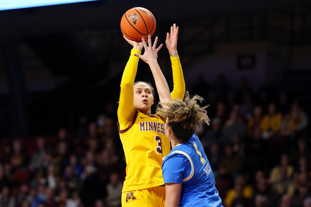 Minnesota Golden Gophers guard Amaya Battle, left, shoots over UCLA Bruins guard Kiki Rice (1) during the second half of an NCAA college basketball game, Wednesday, Jan. 14, 2026, in Minneapolis. (AP Photo/Matt Krohn)