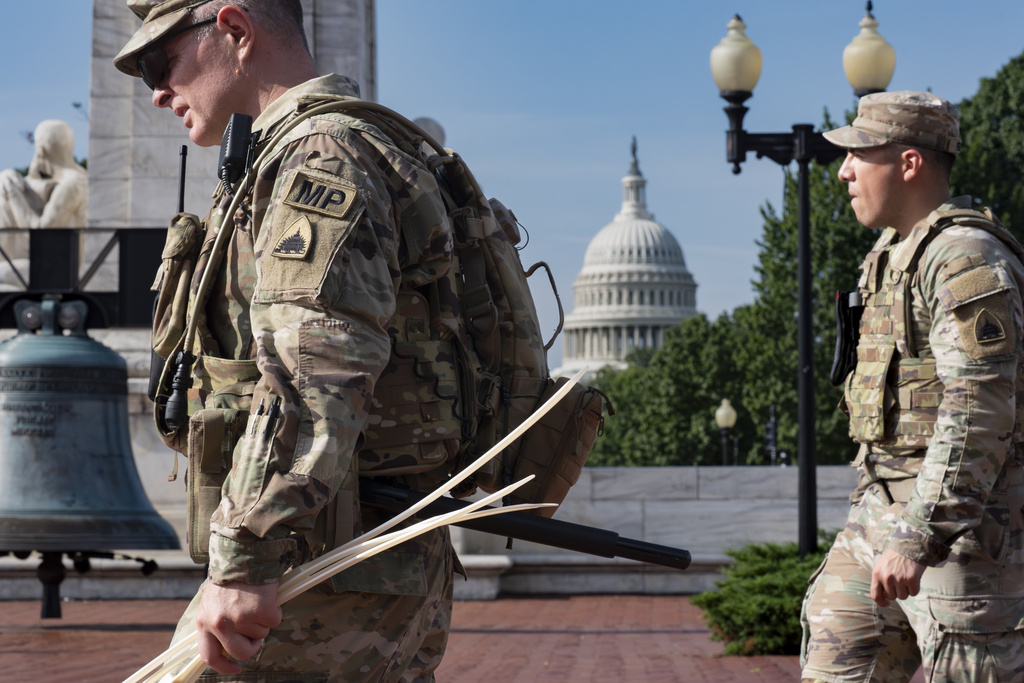A National Guard military police officer carries a handful of zip ties to use as handcuffs while keeping watch as travelers arrive at Union Station near the Capitol in Washington, Aug. 14, 2025 (AP Photo/J. Scott Applewhite)