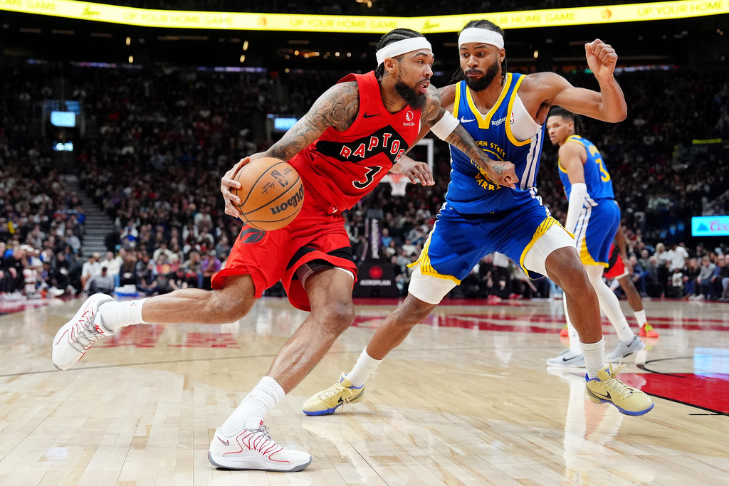 Toronto Raptors forward Brandon Ingram (3) commits an offensive foul against Golden State Warriors guard Moses Moody during the second half of an NBA basketball game in Toronto, Sunday, Dec. 28, 2025. (Frank Gunn/The Canadian Press via AP)