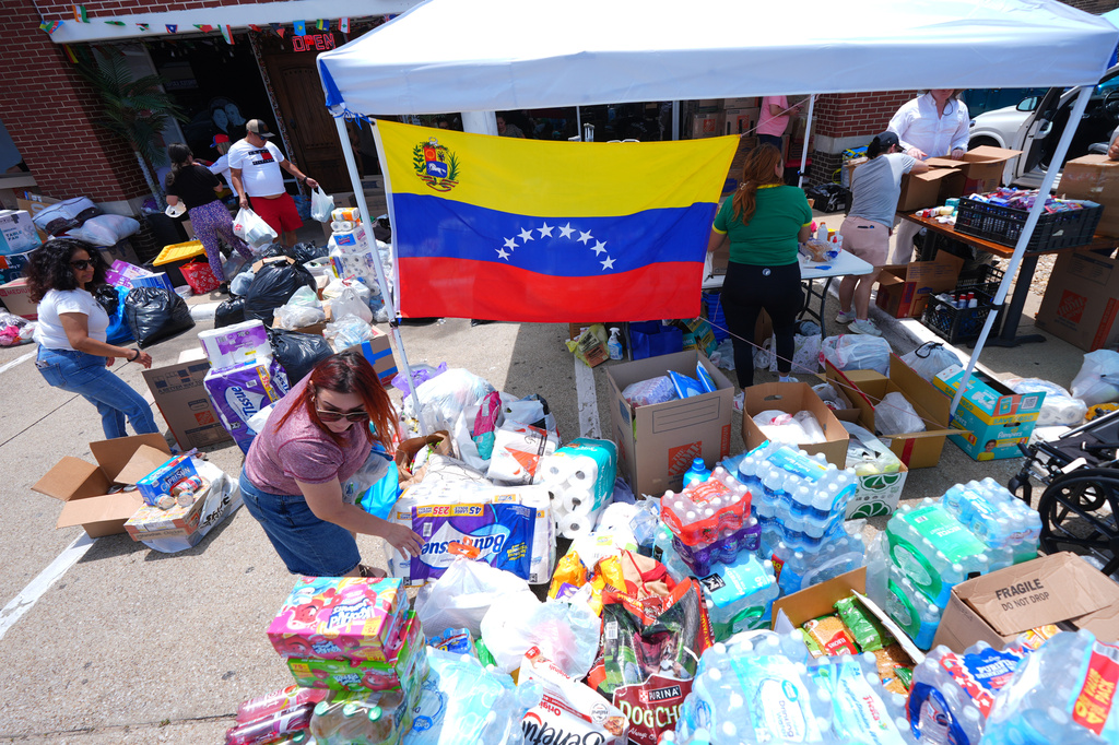 Volunteers sort supplies to send to Venezuelan earthquake victims during an aid donation drive in the Dallas suburb of Carrollton, Texas, Saturday, June 27, 2026. (AP Photo/LM Otero)