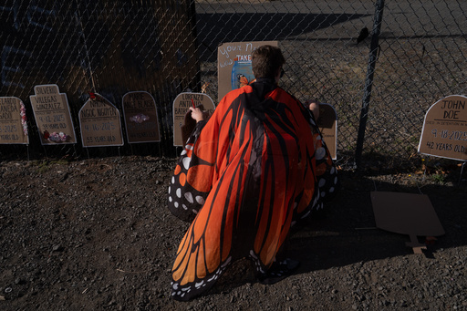 A protester puts out plaques for a memorial outside a U.S. Immigration and Customs Enforcement facility on Sunday, Sept. 28, 2025, in Portland, Ore. (AP Photo/Jenny Kane) A protester puts out plaques for a memorial outside a U.S. Immigration and Customs Enforcement facility on Sunday, Sept. 28, 2025, in Portland, Ore. (AP Photo/Jenny Kane)
