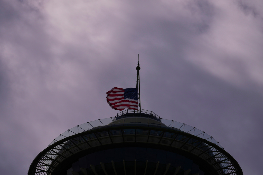 The U.S. flag flies at half staff at the Space Needle the day after a shooting at Seattle Center during the Bite of Seattle food festival, Monday, July 27, 2026. (AP Photo/Lindsey Wasson)
