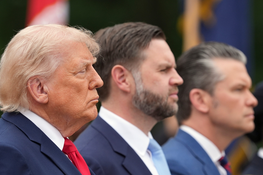 President Donald Trump, from left, Vice President JD Vance and Defense Secretary Pete Hegseth attend a ceremony at the Tomb of the Unknown Soldier in Arlington National Cemetery on Memorial Day, Monday, May 25, 2026, in Arlington, Va. (AP Photo/Alex Brandon)