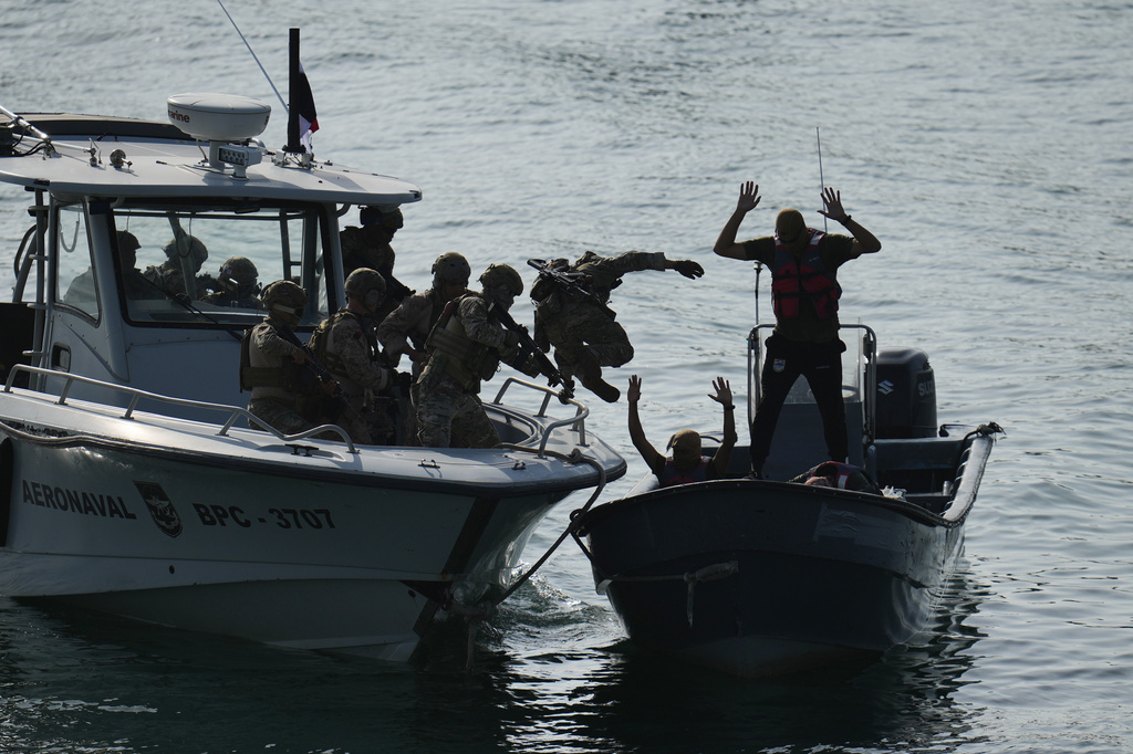 Military personnel train to board boats during a U.S.-sponsored multinational military exercise in Panama City, Thursday, Aug. 13, 2026. (AP Photo/Matias Delacroix)