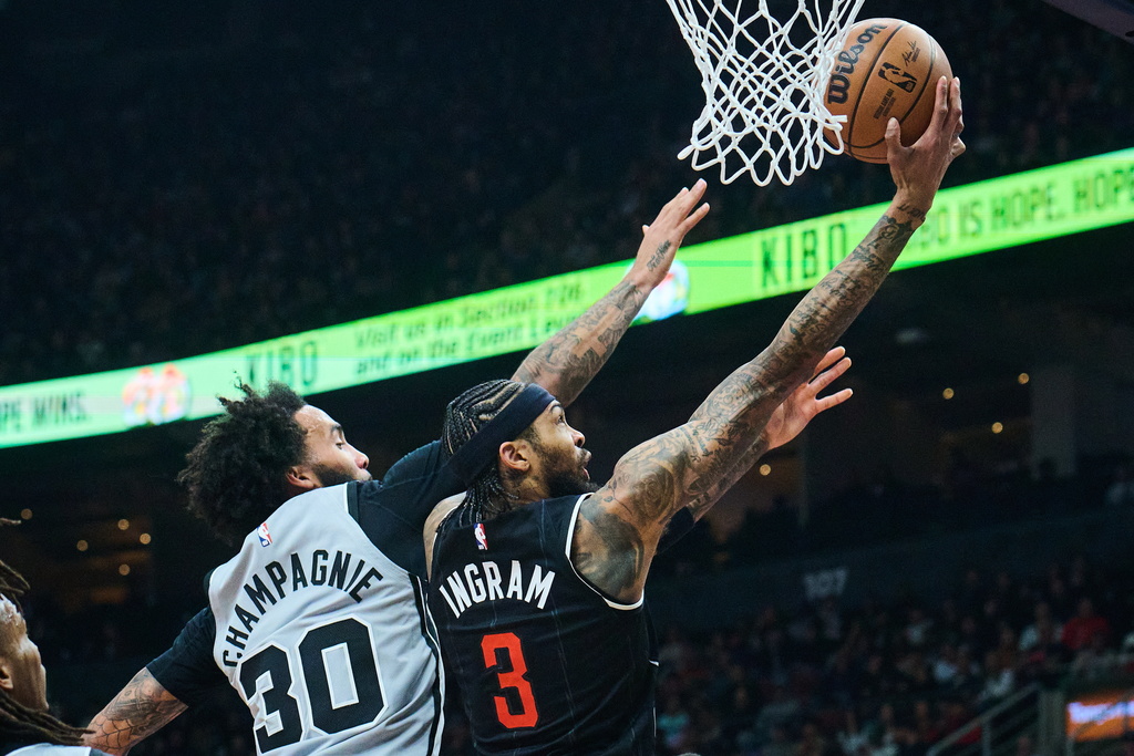 Toronto Raptors' Brandon Ingram (3) drives to the net past San Antonio Spurs' Julian Champagnie (30) during the first half of an NBA basketball game in Toronto, Wednesday, Feb. 25, 2026. (Sammy Kogan/The Canadian Press via AP)