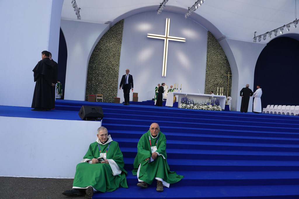 Priests sit before a Mass celebrated by Pope Leo XIV at the Sanctuary of Our Lady of Lourdes, France Sunday, Sept. 27, 2026. (AP Photo/Thibault Camus)