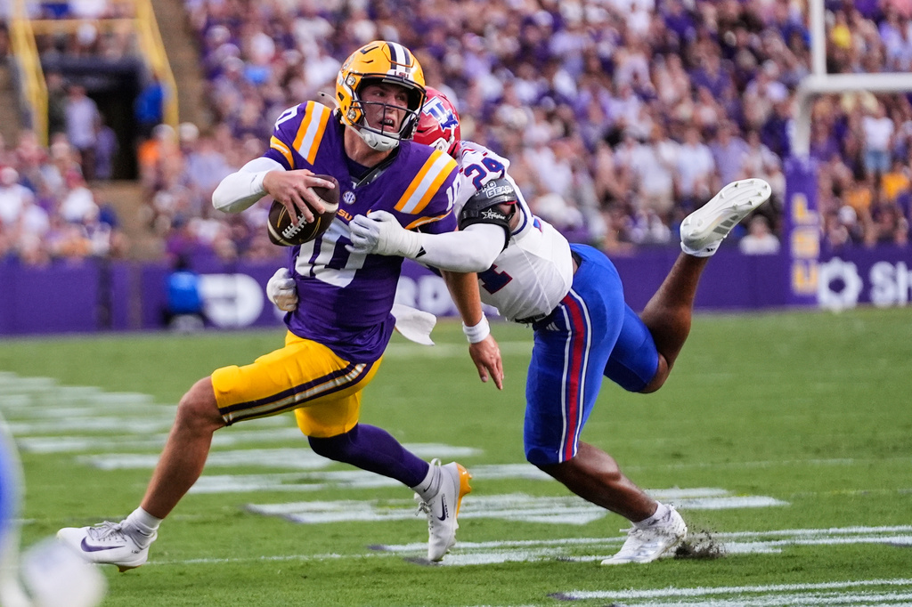 LSU quarterback Sam Leavitt (10) is tackled by Louisiana Tech linebacker Alonzo Jackson Jr. (24) in the first half of an NCAA college football game, Saturday, Sept. 12, 2026 in Baton Rouge, La. (AP Photo/Gerald Herbert)
