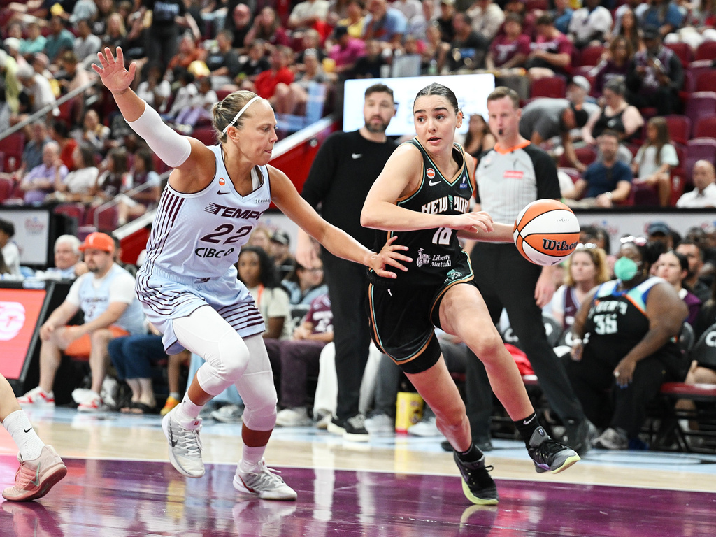 Toronto Tempo's Julie Allemand (22) defends against New York Liberty's Pauline Astier (18) during the second half of a WNBA basketball game in Montreal, on Sunday, July 12, 2026. (Graham Hughes/The Canadian Press via AP)