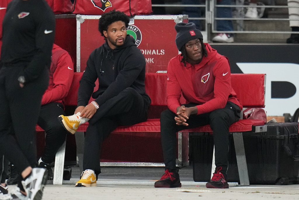 Arizona Cardinals quarterback Kyler Murray, left, and wide receiver Marvin Harrison Jr. sit on the bench during the first half of an NFL football game against the Jacksonville Jaguars Sunday, Nov. 23, 2025, in Glendale, Ariz. (AP Photo/Rick Scuteri)