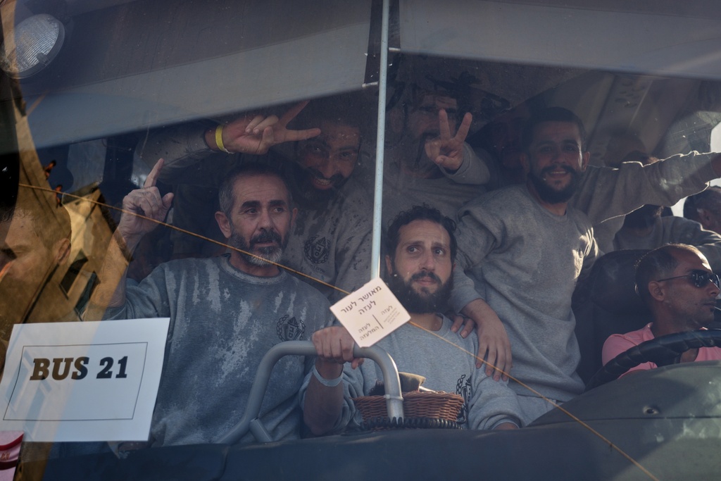 Freed Palestinian prisoners arrive in the Gaza Strip after their release from Israeli jails under a ceasefire agreement between Hamas and Israel, in Khan Younis, southern Gaza Strip, Monday, Oct. 13, 2025. (AP Photo/Jehad Alshrafi)