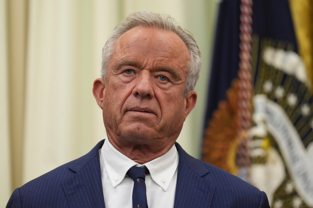 Health and Human Services Secretary Robert F. Kennedy Jr. listens as President Donald Trump speaks during an event about healthcare in the Oval Office of the White House, Friday Sept. 18, 2026, in Washington. (AP Photo/Jacquelyn Martin)