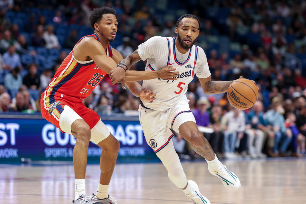 Los Angeles Clippers forward Derrick Jones Jr. (5) tries to drive past New Orleans Pelicans forward Trey Murphy III (25) in the first half of an NBA basketball game in New Orleans, Thursday, March 19, 2026. (AP Photo/Peter Forest)
