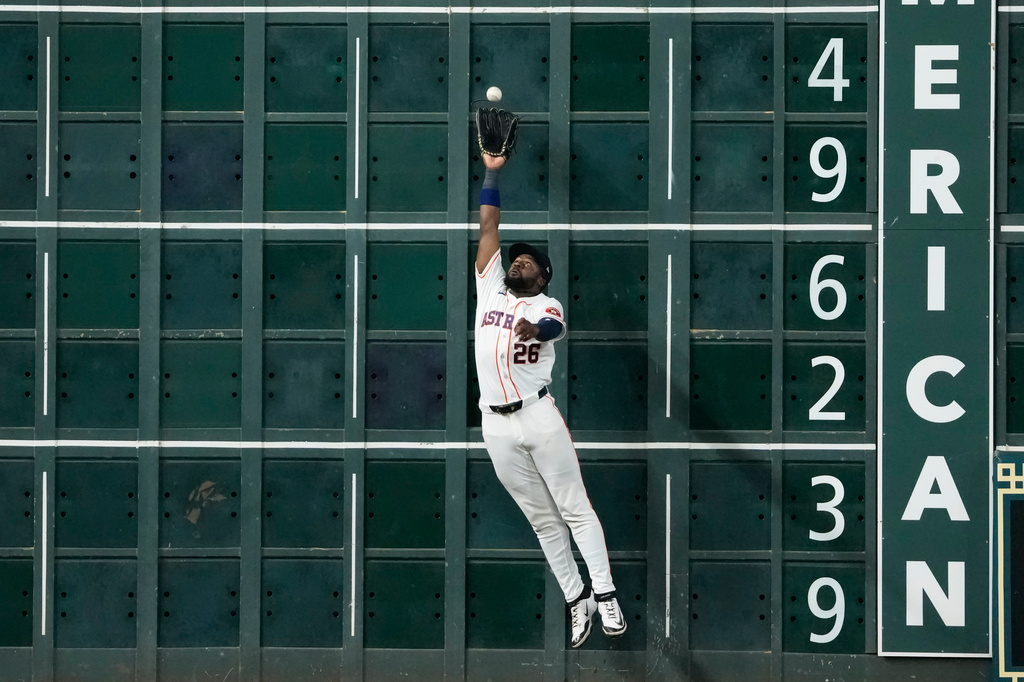 Houston Astros left fielder Taylor Trammell catches a fly ball by Minnesota Twins' Josh Bell during the ninth inning of a baseball game Wednesday, July 1, 2026, in Houston. (AP Photo/David J. Phillip)