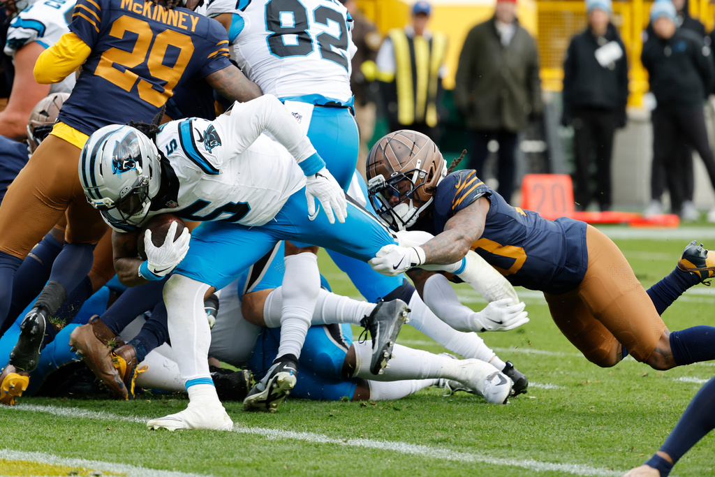 Carolina Panthers running back Rico Dowdle (5) scores a touchdown against the Green Bay Packers during the second half of an NFL football game Sunday, Nov. 2, 2025, in Green Bay, Wis. (AP Photo/Mike Roemer)
