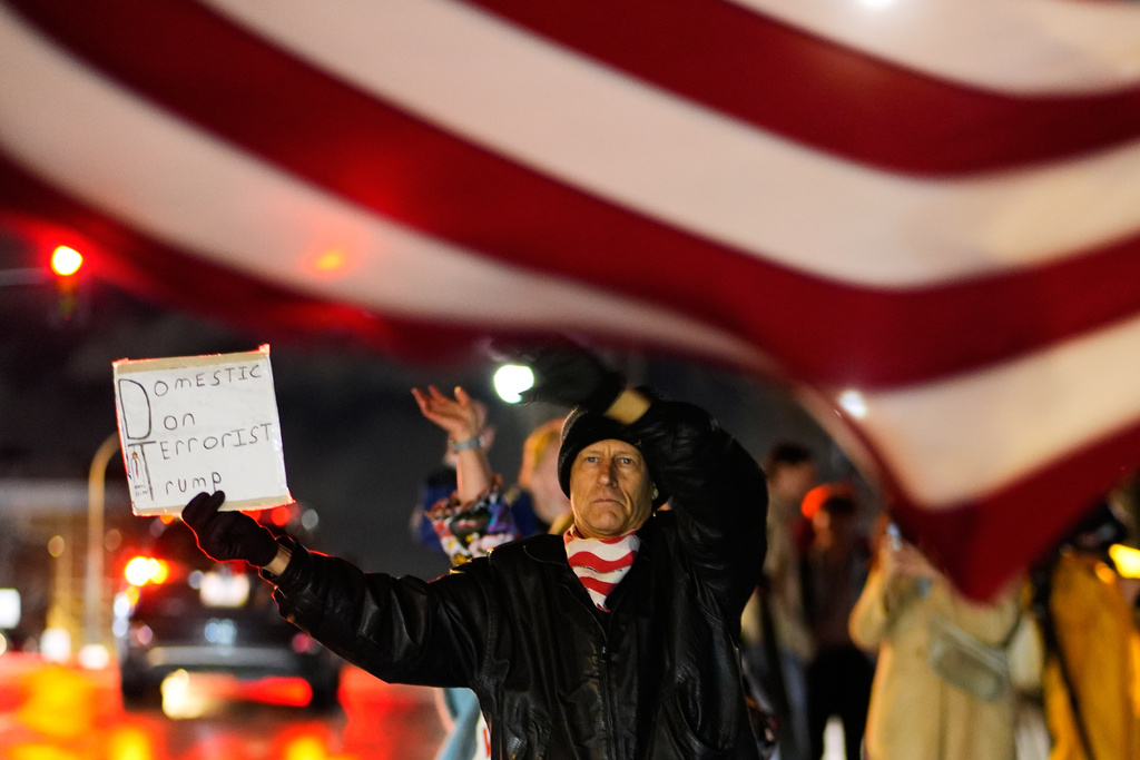 John Brown protests during a rally for Renee Good, who was fatally shot by an ICE officer in Minneapolis the day before, Thursday, Jan. 8, 2026, in Kansas City, Mo. (AP Photo/Charlie Riedel)