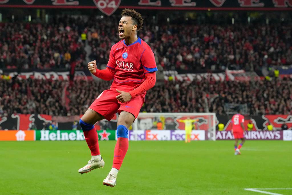 PSG's Desire Doue celebrates after scoring his side's second goal during a Champions League opening phase soccer match between Bayer Leverkusen and Paris Saint-Germain in Leverkusen, Germany, Tuesday, Oct. 21, 2025. (AP Photo/Martin Meissner)