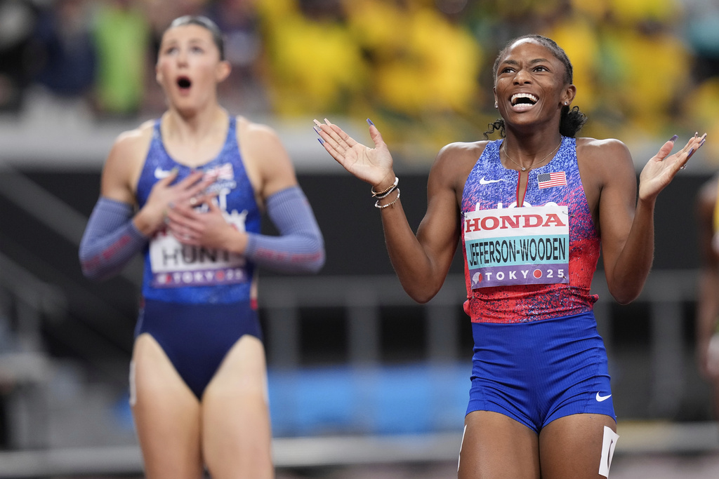 United States' Melissa Jefferson-Wooden, right, celebrates after winning gold medal in the women's 200 meters final at the World Athletics Championships in Tokyo, Friday, Sept. 19, 2025. (AP Photo/Eugene Hoshiko)