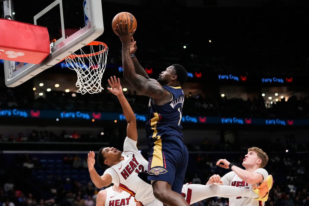 New Orleans Pelicans forward Zion Williamson (1) goes to the basket against Miami Heat guard Dru Smith (12) in the first half of an NBA basketball game, Wednesday, Feb. 11, 2026, in New Orleans. (AP Photo/Gerald Herbert)