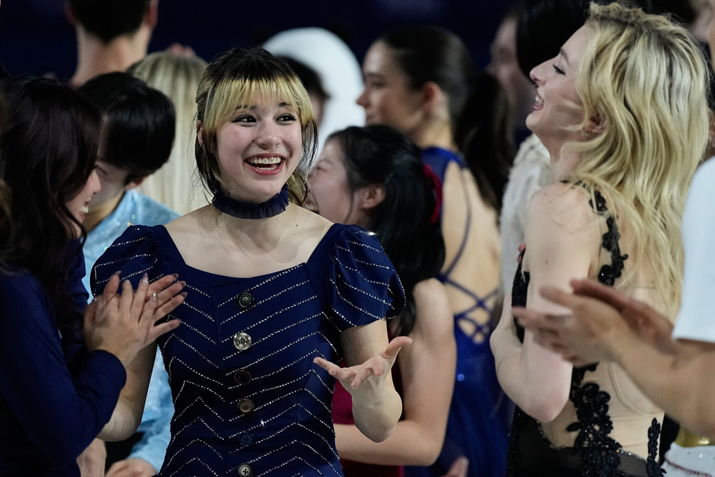 Alysa Liu of the United States, center, reacts with other athletes after performing in the figure skating exhibition at the 2026 Winter Olympics, in Milan, Italy, Saturday, Feb. 21, 2026. (AP Photo/Ashley Landis)