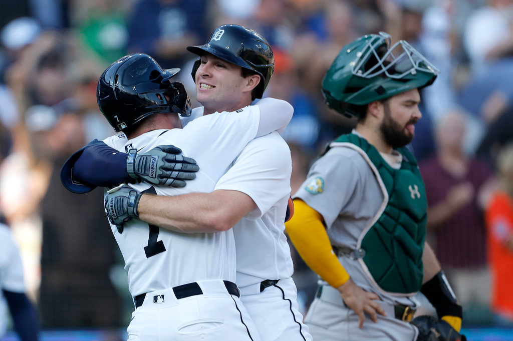 Detroit Tigers' Colt Keith celebrates his two-run home run with Kevin McGonigle (7) after crossing the plate past Athletics catcher Shea Langeliers, right, during the first inning of a baseball game Tuesday, July 7, 2026, in Detroit. (AP Photo/Duane Burleson)