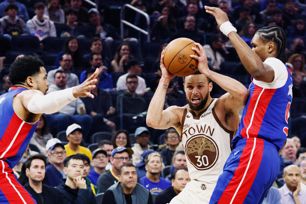 Golden State Warriors guard Stephen Curry (30) is double teamed by the Detroit Pistons in the first half of an NBA game in San Francisco, Friday, Jan. 30, 2026. (Santiago Mejia/San Francisco Chronicle via AP)
